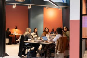 Modern coworking space showing hot desks, meeting rooms, and shared amenities demonstrating how coworking space works for professionals
